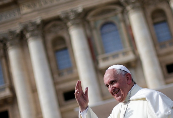 Pope Francis waves as he leads his weekly audience in Saint Peter's Square at the Vatican, October 8, 2014.