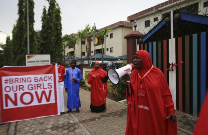 A campaigner from '#Bring Back Our Girls' shouts slogans during a rally calling for the release of the chibok school girls who were abducted by Boko Haram militants, in Abuja, Nigeria, October 17, 2014. Nigeria said on Friday it had agreed a ceasefire with Islamist militants Boko Haram and reached a deal for the release of more than 200 schoolgirls kidnapped by the group six months ago.