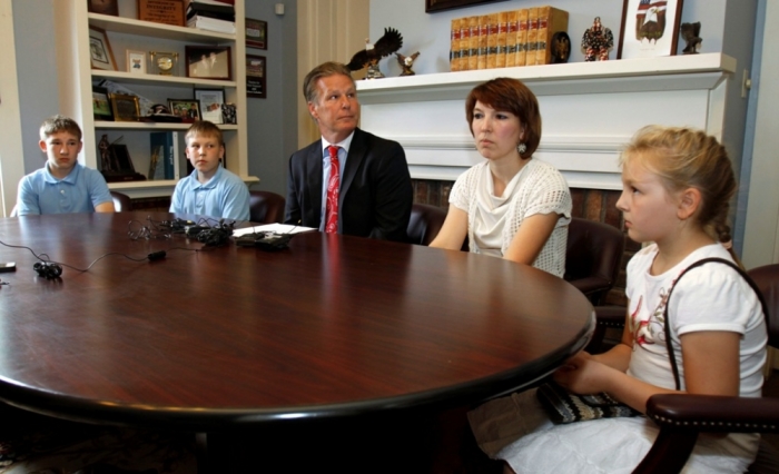 The family of Jeffrey Fowle, his wife Tatyana (2nd R) and children Alex (L), Chris (2nd L) and Stephanie, surrounds family attorney Tim Tepe after Tepe read a family statement in Lebanon, Ohio, August 12, 2014. The statement apologized for Fowle's actions when he visited North Korea in May this year. Fowle was arrested by North Korean authorities for leaving a Bible under a bin in the toilet at a club for foreign sailors, a source familiar with Fowle's case told Reuters.