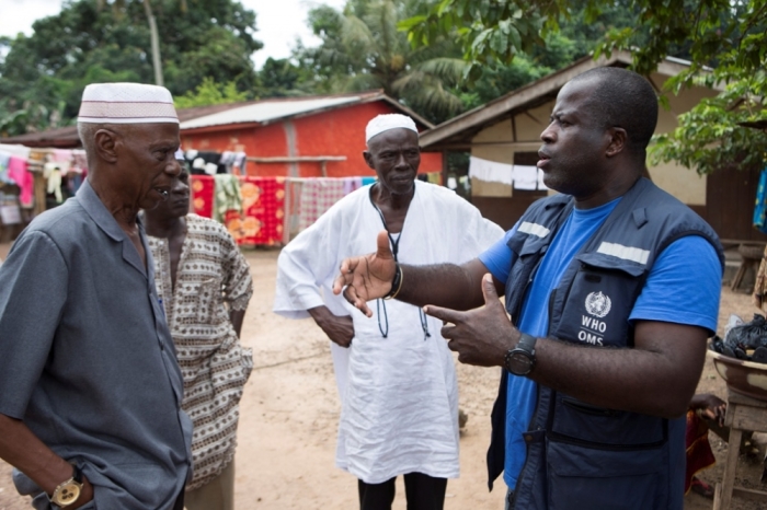Kande-Bure Kamara from WHO has a discussion with community leaders in Kamasondo Village at Port Loko District October 8, 2014. More than 5,000 people have died of the viral haemorrhagic fever in West Africa, mostly in Liberia, neighbouring Sierra Leone and Guinea.