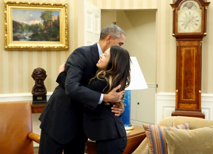 U.S. President Barack Obama hugs Dallas nurse Nina Pham at the Oval Office in Washington, October 24, 2014. Obama gave a big hug on Friday to Nina Pham, the Dallas nurse who survived a bout with Ebola. Obama met Pham in the Oval Office shortly after her release from a nearby hospital after recovering from the virus. Pham contracted the virus while treating Liberian national Thomas Eric Duncan who traveled to the U.S. after having direct contact with a young woman who died from Ebola. Duncan later died of Ebola in a Dallas hospital. Pham had been undergoing treatment at the National Institutes of Health in Bethesda, Maryland, since Oct. 16.