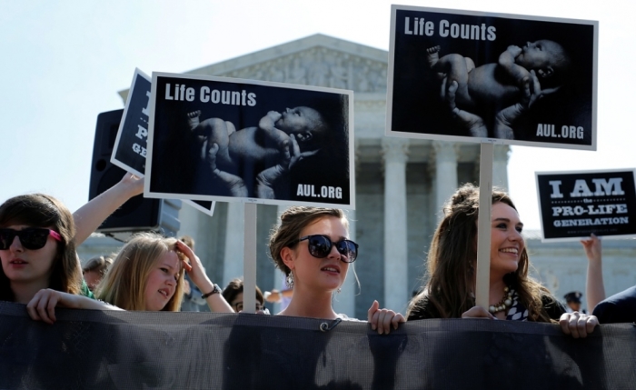 Pro-life advocates wait for the U.S. Supreme Court ruling in the Hobby Lobby case to be announced in Washington, June 30, 2014.