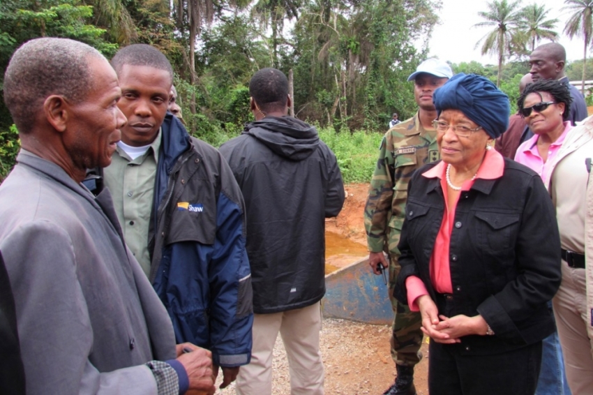 Liberian President Ellen Johnson-Sirleaf speaks to villagers about Ebola virus precautions outside Ganta, Liberia, October 7, 2014. International aid to battle the Ebola epidemic in Liberia is arriving too slowly, Sirleaf said on Wednesday, though she said there were early signs that the outbreak in her West African country could be "in decline". On a tour of the villages of remote northern Liberia, Johnson Sirleaf told Reuters that she wanted to give her people hope that the virus could be beaten, though the World Health Organization said last week there were few indications of the epidemic being brought under control.