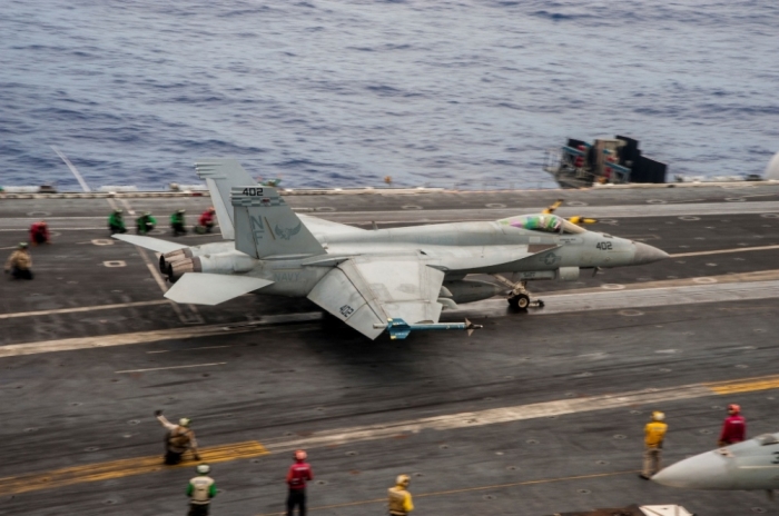 An F/A-18E Super Hornet from the 'Dambusters' of Strike Fighter Squadron (VFA) 195 launches from the flight deck of the Nimitz-class aircraft carrier USS George Washington (CVN 73) in this U.S., October 26, 2014.