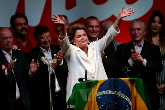 Brazil's President and Workers' Party presidential candidate Dilma Rousseff celebrates during a news conference after disclosure of the election results, in Brasilia, October 26, 2014. Rousseff narrowly won re-election on Sunday after convincing voters that her party's strong record of reducing poverty over the last 12 years was more important than a recent economic slump.