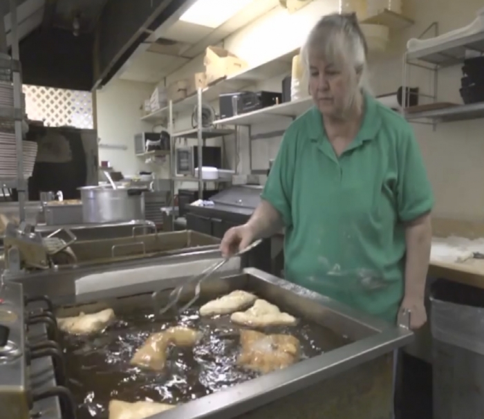 Carole Hinder, owner of Mrs. Lady's Mexican Food in Spirit Lake, Iowa, is preparing fried food for the customers of her establishment. In August of 2013, the IRS seized Hinder's bank account, which totaled nearly ,000.