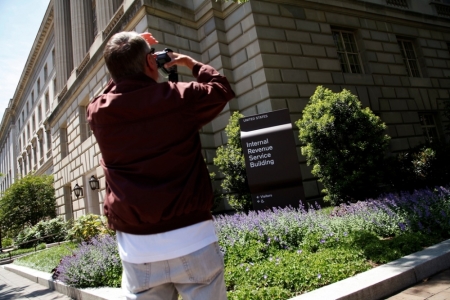 A visitor takes a picture of the Internal Revenue Service building in Washington, May 14, 2013. Senate Republican leader Mitch McConnell called on President Barack Obama on Tuesday to make available for questioning everyone who knew about the Internal Revenue Service's targeting of conservative groups, and demanded