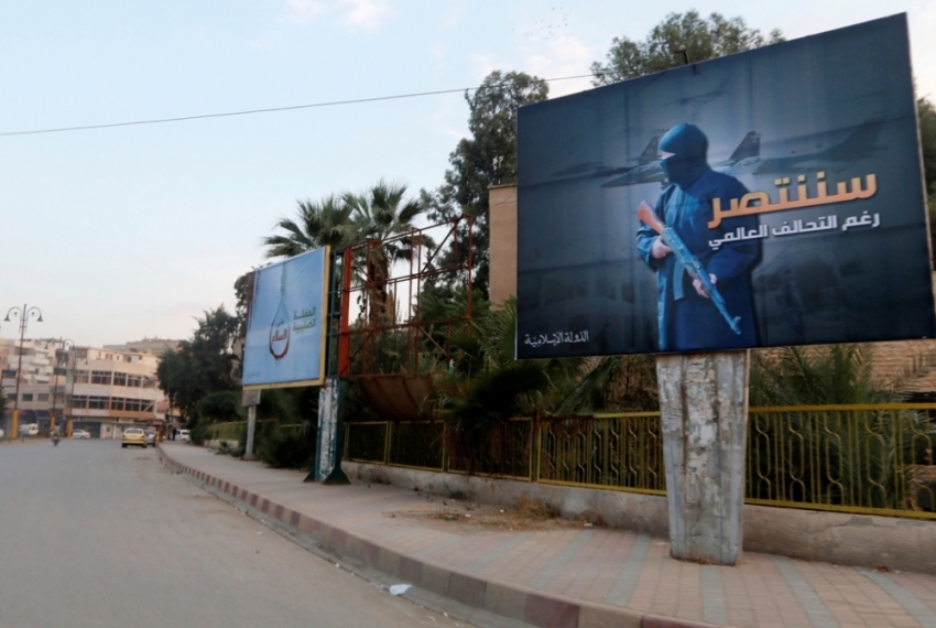 Islamic State billboards are seen along a street in Raqqa, eastern Syria, which is controlled by the Islamic State, October 29, 2014. The billboard (R) reads: "We will win despite the global coalition."