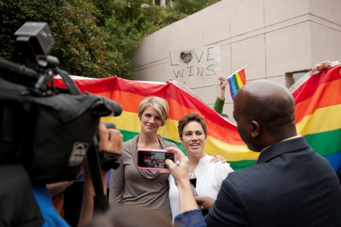 Allyson Creel (center left) and Jennifer Kolb (center right) talk to the media after getting married outside of Mecklenburg County Register of Deeds office in Charlotte, North Carolina, October 13, 2014. Monday was the first day that Mecklenburg County issued marriage licenses to gay couples. The couple was married by Jessica Milicevic (L).