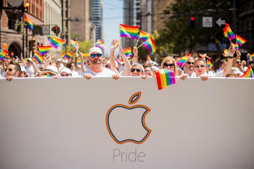 Apple employees carry rainbow flags as they march in the San Francisco Gay Pride Festival in California, June 29, 2014. Thousands of Apple employees donned specially designed T-shirts at the festival and marched in unison. This year's turnout was largest in the company's history, several Apple employees told Reuters.