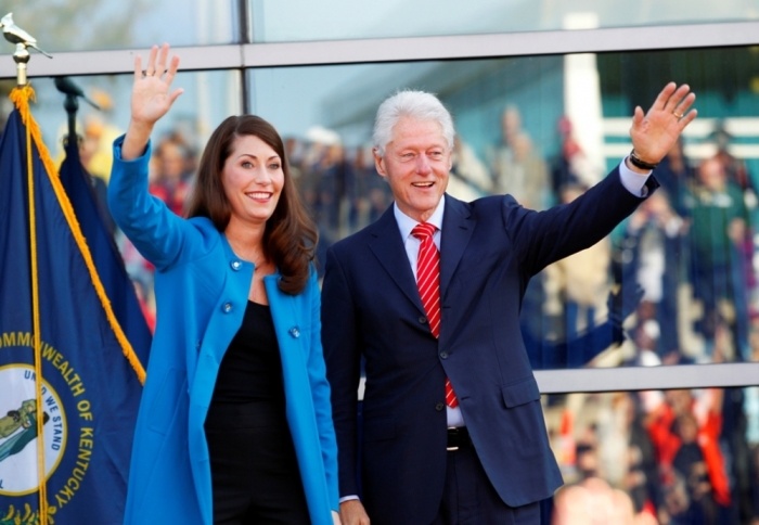 Former U.S. President Bill Clinton and Kentucky's Democratic Senate candidate Alison Lundergan Grimes wave to the crowd during a campaign event at The Muhammad Ali Center in Louisville, Kentucky, October 30, 2014. Grimes is running against current Senate minority leader Mitch McConnell.