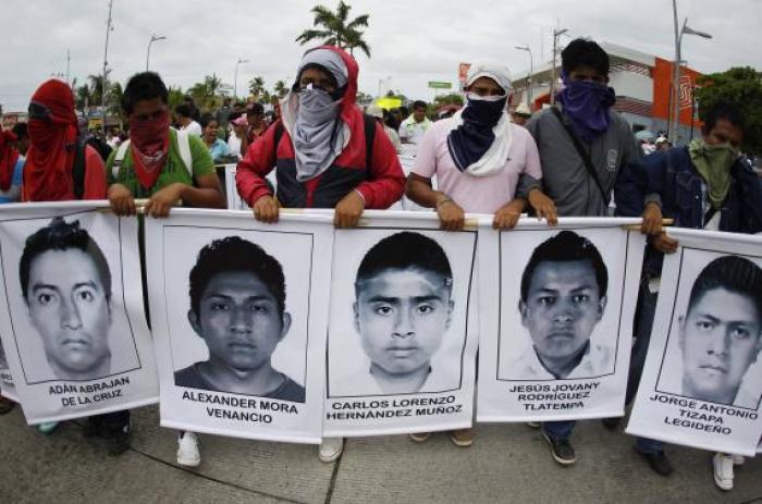 Students from the Ayotzinapa Teacher Training College carry photographs of missing students during a march in Acapulco October 17, 2014.