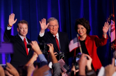 U.S. Republican Senator Rand Paul from Kentucky (L) waves with Senate Minority Leader Mitch McConnell, R-Ky., and McConnell's wife, former United States Secretary of Labor Elaine Chao, at McConnell's midterm election night victory rally in Louisville, Kentucky, November 4, 2014.