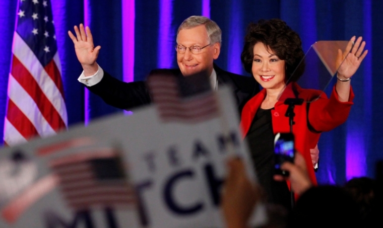 U.S. Senate Minority Leader Mitch McConnell, R-Ky., waves to supporters with his wife, former United States Secretary of Labor Elaine Chao, at his midterm election night rally in Louisville, Kentucky, November 4, 2014. Television news networks are projecting that McConnell will win the election.