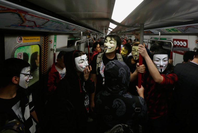 Pro-democracy protesters wearing Guy Fawkes masks take a subway train to a protest site occupied by them as part of the Occupy Central civil disobedience movement in Hong Kong November 5, 2014, the day marking Guy Fawkes Night. Students calling for full democracy for Chinese-ruled Hong Kong are hoping to take their protest to Communist Party rulers in Beijing and are expected to announce details of their new battle plan on Thursday.