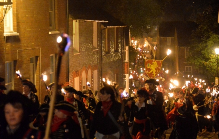 Participants in costume hold burning torches and crosses as they take part in one of a series of processions during Bonfire night celebrations in Lewes, southern England November 5, 2013. The processions and bonfire mark the uncovering of Guy Fawkes' 'Gunpowder Plot' to blow up the Houses of Parliament in 1605, and commemorates the memory of Lewes' seventeen Protestant martyrs.