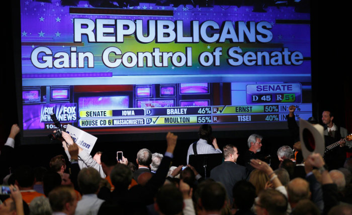 Republican supporters cheer as a giant TV screen displays the results of the Senate race in the U.S. midterm elections in Denver, Colorado, November 4, 2014.