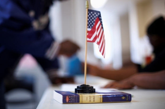 A miniature flag rests on a copy of the Bible at voter registration at West Philadelphia High School.