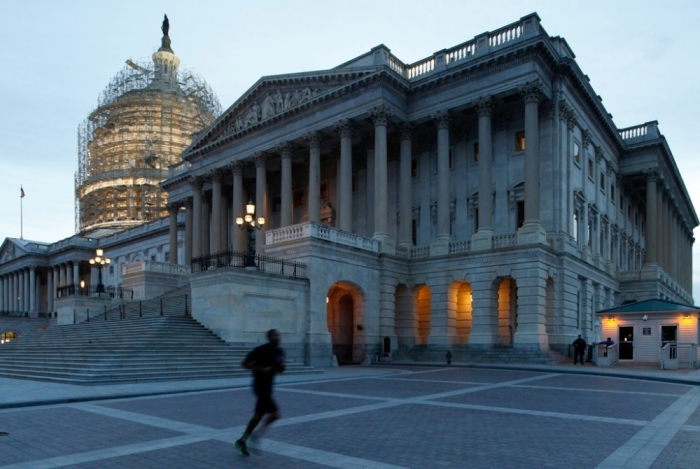 Evening falls over the U.S. Capitol dome and the Senate chambers (R), during midterm elections day, in Washington, November 4, 2014.