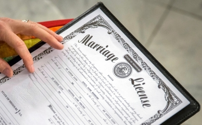 The Rev. Katie Hotze-Wilton signs a marriage license at a same-sex wedding ceremony at City Hall in St. Louis, Missouri, November 5, 2014. Missouri's ban on same-sex marriage is unconstitutional, a St. Louis circuit judge ruled Wednesday, adding momentum to efforts in states across the country to legalize gay nuptials.