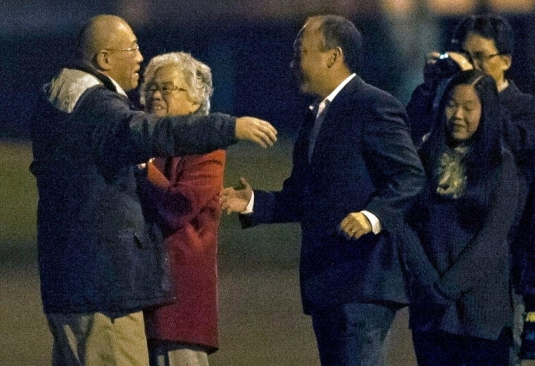 Kenneth Bae (L) reunites with his family at U.S. Air Force Joint Base Lewis-McChord in Fort Lewis, Washington November 8, 2014. North Korea freed two Americans, Bae and Matthew Todd Miller, from prison and they returned to the United States on Saturday after the surprise involvement of the top-ranking U.S. intelligence official in their release. Bae, a missionary from Washington state, was arrested in North Korea in November 2012 and sentenced to 15 years hard labor for crimes against the state. Miller, who reportedly was tried on an espionage charge, had been in custody since April this year and sentenced to six years of hard labor.