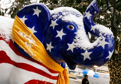 A pedestrian walks past a snow-covered porcelain elephant, painted to represent the traditional symbol of the Republican party, after a snowfall in Washington, December 5, 2007.