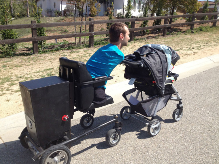 Limbless evangelist and inspirational speaker Nick Vujicic pushing his son, Kiyoshi, in the stroller.