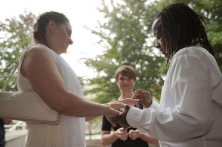 Kathy Stewart (R) places a ring on the finger of her partner, Vicky Mangus (L), during a wedding ceremony outside of the Mecklenburg County Register of Deeds office in Charlotte, North Carolina, October 13, 2014.