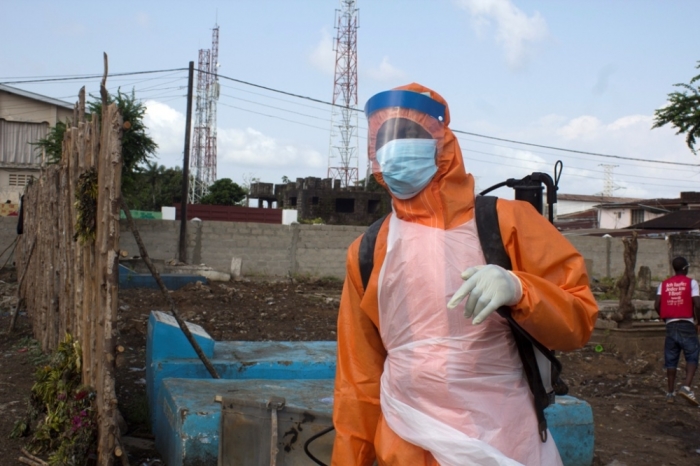 A health worker prepares to disinfect a van used for burial purposes in Freetown, Sierra Leone, November 10, 2014.