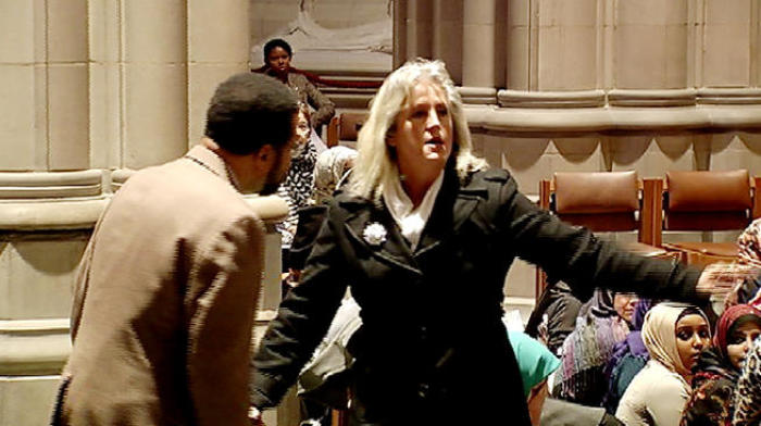 Christine Weik, 50, at Washington National Cathedral disrupts first Muslim prayer service Friday afternoon and shouts, 'We have built, and allowed you here in mosques across this country. Why can't you worship in your mosque, and leave our churches alone?' Nov. 14, 2014.