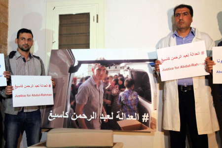 Colleagues of U.S. aid worker Abdul-Rahman Kassig carry signs during a news conference calling for his release in Tripoli, northern Lebanon November 8, 2014. Kassig, a 26-year-old humanitarian worker from Indiana whose first name was Peter before he converted to Islam while in captivity, was abducted on October 1, 2013. He is currently being held hostage by Islamic State militants, who threatened to behead him in a video issued last month that showed the beheading of British aid worker Alan Henning, 47. The words on the 3rd left read, "Justice to Abdul-Rahman".