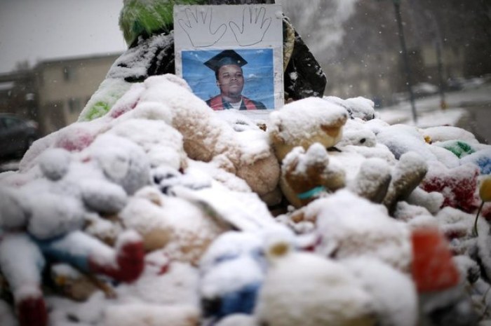 Snow falls on a memorial on the 100th day since the shooting death of Michael Brown in Ferguson, Missouri November 16, 2014.