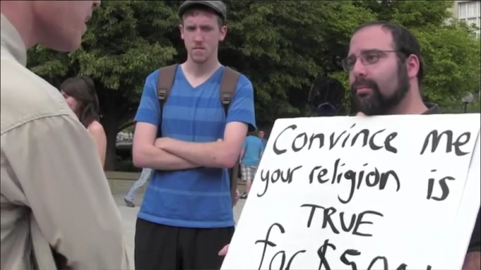 Dave Muscato (R) participating in a religious debate in a video posted on April 20, 2012.
