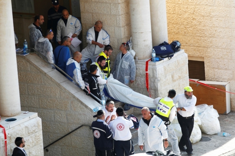 Israeli emergency personnel carry the body of a victim from the scene of an attack at a Jerusalem synagogue, November 18, 2014. Two Palestinians armed with a meat cleaver and a gun killed four people in a Jerusalem synagogue on Tuesday before being shot dead by police, the deadliest such incident in six years in the holy city amid a surge in religious conflict.