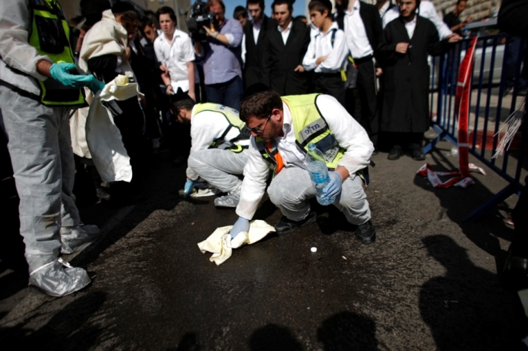 Members of the Israeli Zaka emergency response team clean blood at the scene of an attack at a Jerusalem synagogue, November 18, 2014. Two Palestinians armed with a meat cleaver and a gun killed four people in a Jerusalem synagogue on Tuesday before being shot dead by police, the deadliest such incident in six years in the holy city amid a surge in religious conflict.