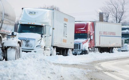 Trucks sit stranded on a closed New York State Thruway in the town of Cheektowaga near Buffalo, New York, November 20, 2014.