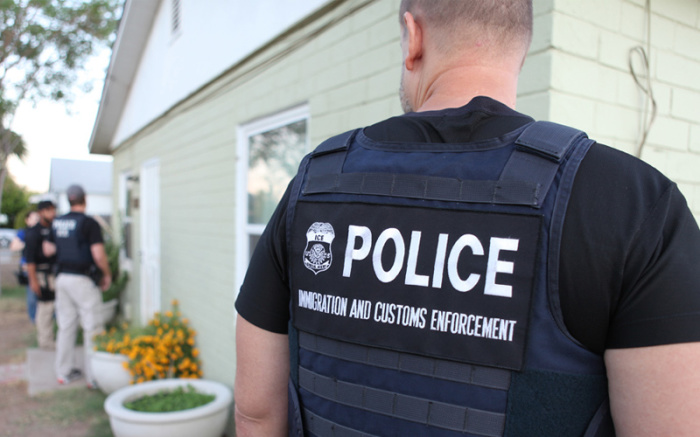 Immigration and Customs Enforcement agents making an effort to deport an undocumented illegal immigrant.