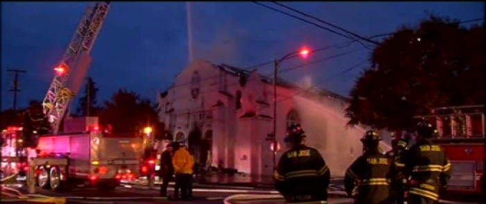 Firefighters battle a four-alarm blaze at Holy Cross church in San Jose, California, November 16, 2014.