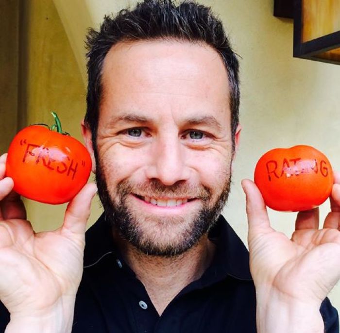 Kirk Cameron posing with 2 tomatos.