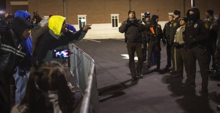 As the nation awaits a grand jury decision in the case of Michael Brown and police officer Darren Wilson, columnist and pastor Shane Idleman asks, "What if?" Above photo: According to Reuters, protesters shout towards police as they demand the criminal indictment of a white police officer who shot dead an unarmed black teenager in August, outside the Ferguson Police Station in Missouri, Nov. 20, 2014.