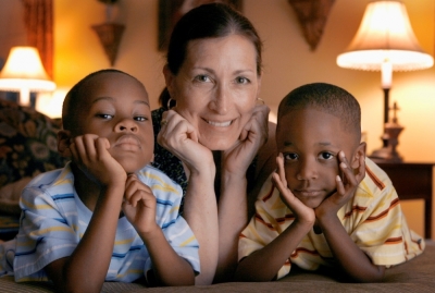 Adoptive mother Theresa Alden with her sons Gavin (L), 6, and Graem, 4, at their residence in Lancaster, Pennsylvania, June 10, 2008. Alden's children, Gavin and Graem, are two of around 140,000 adopted in the United States each year. Of those, around 20,000 are adopted by adults of a different race. But black children in foster care are less likely to be adopted into a family than children from other races and U.S. laws governing adoption are failing, according to a major new report.