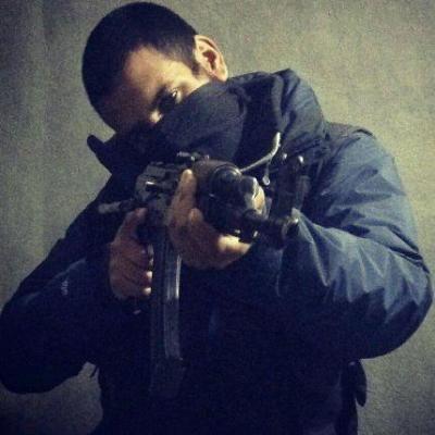 Abu Hussain al-Britani is posing for his Twitter profile picture.