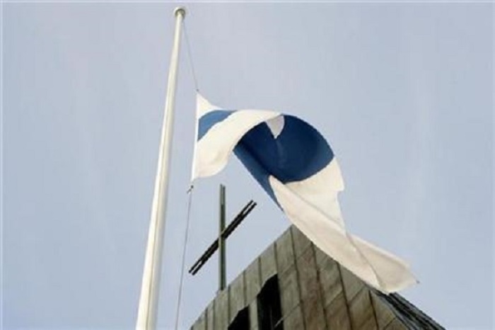 Finland's national flag flies at half-mast near a church in Kauhajoki, about 350 km (217 miles) from Helsinki, September 24, 2008.