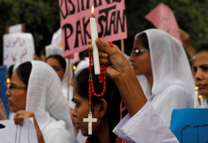 Members of the Pakistani Christian community hold candles during a protest rally to condemn Sunday's suicide attack in Peshawar on a church, with others in Lahore, September 23, 2013. A pair of suicide bombers blew themselves up outside the 130-year-old Anglican church in Pakistan after Sunday mass, killing at least 78 people in the deadliest attack on Christians in the predominantly Muslim country.