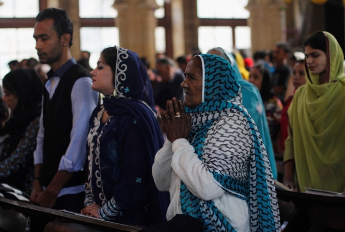 A Pakistani Christian woman attends mass along with others on Christmas day at St Andrew's Church in Karachi, December 25, 2013.