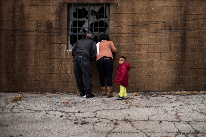 A family looks through the destroyed windows of the Flood Christian Church, which was set a flame during recent unrest in Ferguson, Missouri, November 30, 2014.