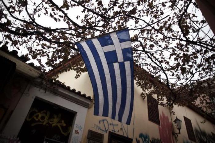 A Greek national flag flutters in the wind at the Plaka district in Athens November 7, 2014.