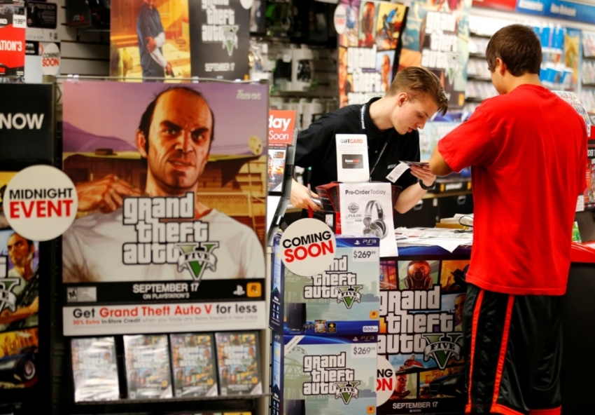Game enthusiasts purchase the latest release of "Grand Theft Auto Five" after the game went on sale at the Game Stop store in Encinitas, California, September 17, 2013.