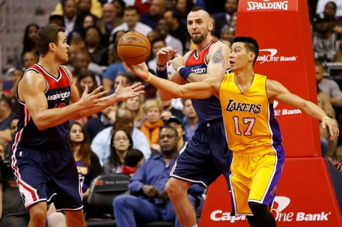Los Angeles Lakers guard Jeremy Lin (17) battles for the ball with Washington Wizards center Marcin Gortat (4) and Wizards forward Kris Humphries (43) in the first quarter at Verizon Center, Washington, D.C., Dec, 3, 2014.