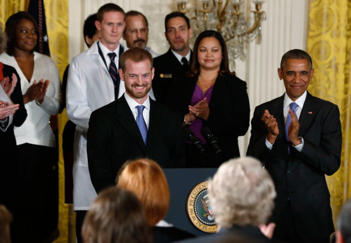 Ebola suvivor Dr. Kent Brantly (L) is applauded by U.S. President Barack Obama (R) prior to the president delivering a statement about the government's Ebola response in the East Room of the White House in Washington, October 29, 2014.